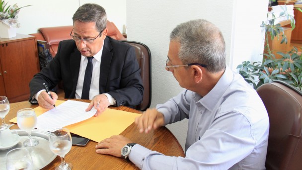 A foto mostra o diretor-geral do Daer, Rogério Uberti, assinando o contrato de reativação de lombadas eletrônicas em rodovias estaduais. Ao lado dele, à mesa, está o diretor administrativo da empresa Kopp Tecnologia.