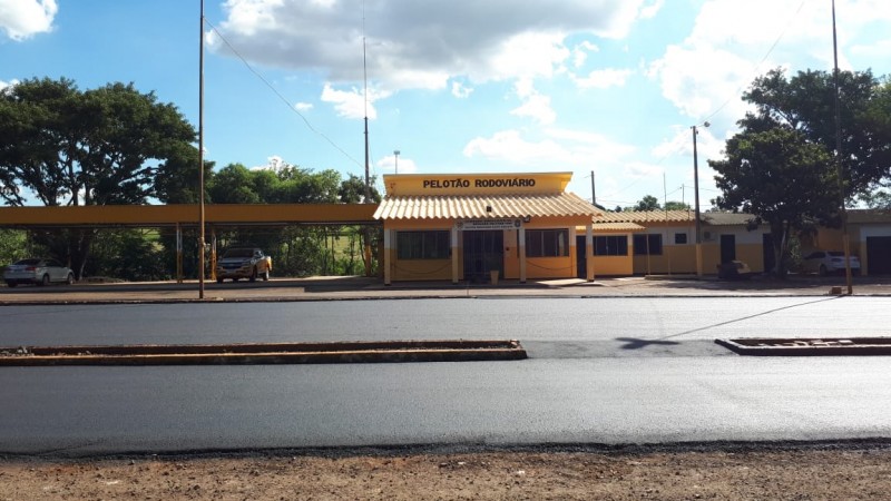 Na foto está presente o prédio amarelo de um pelotão amarelo, além do pavimento devidamente conservado.