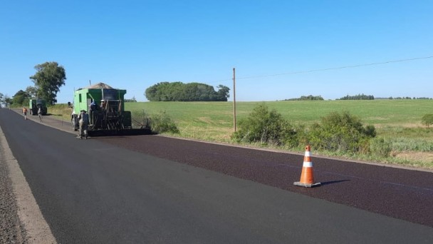 A imagem mostra máquina realizando a compactação da pista.