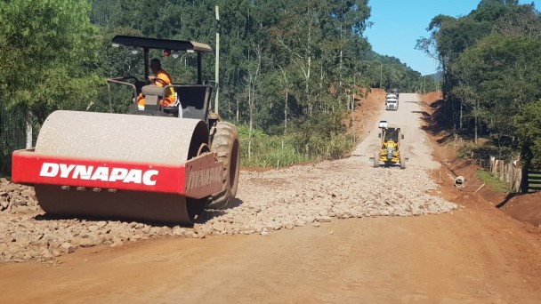 Imagem mostra máquina realizando a compactação da base asfáltica